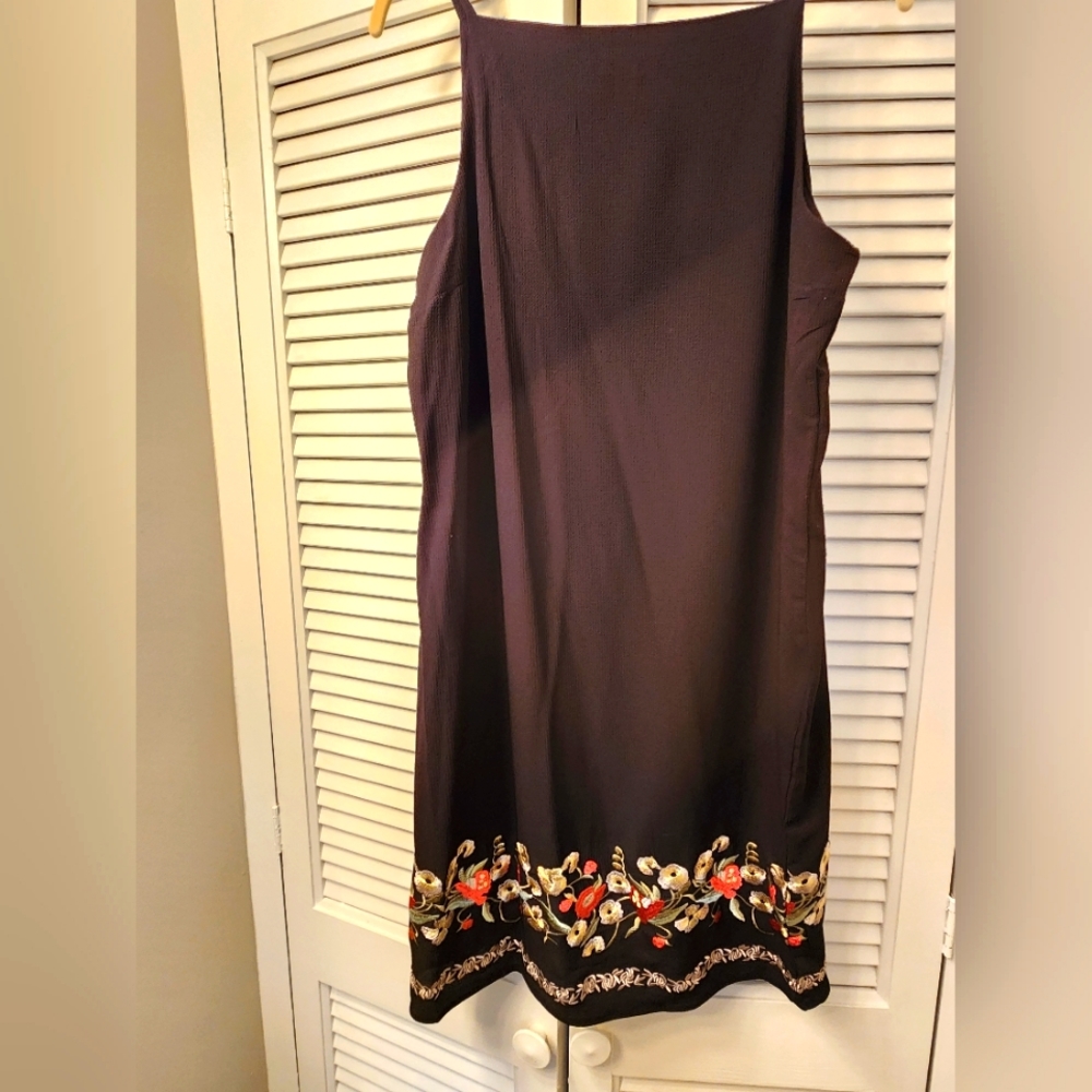 Black dress with floral embroidered detailing at the hem